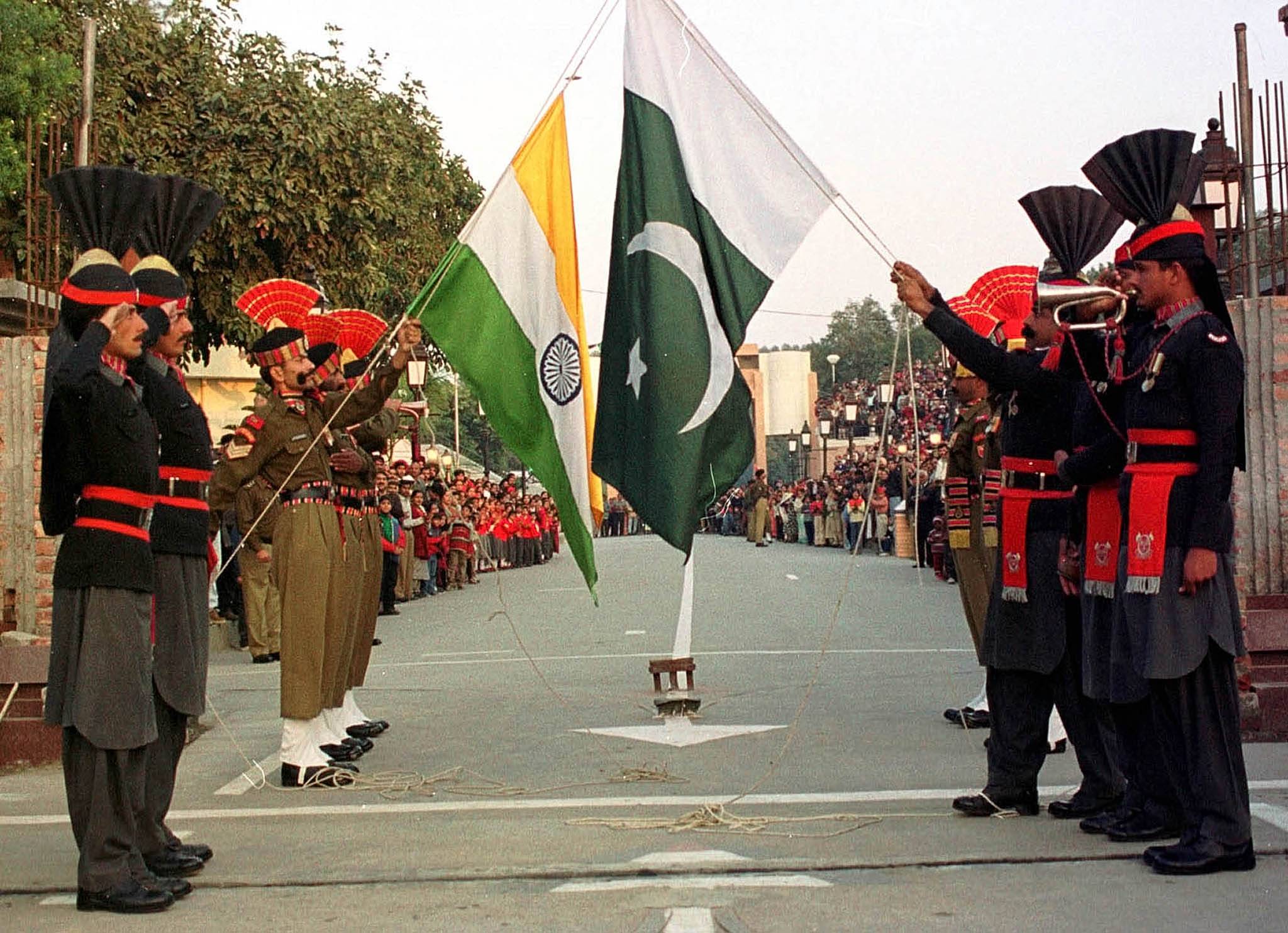PAKISTAN AND INDIA BORDER GUARDS BRING DOWN THEIR NATIONAL FLAG INLAHORE.